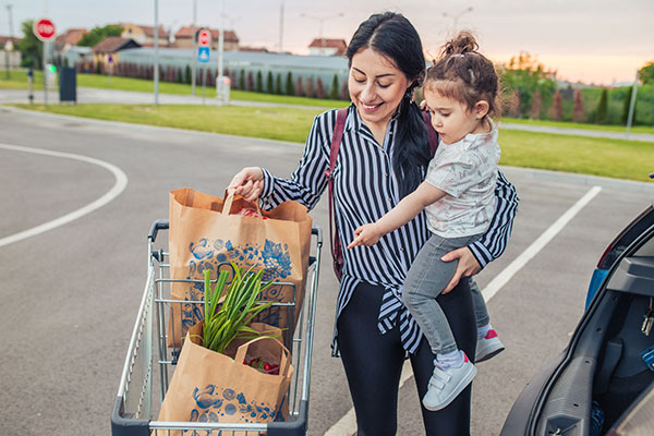 Mom with her child in front of the supermarket