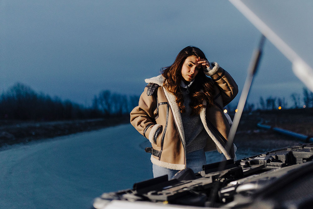 BCAA Road Assistance helping a woman with a dead car battery