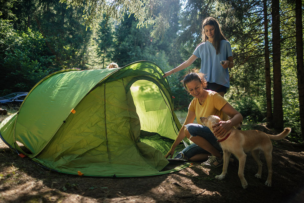Mom and daughter setting up a camp