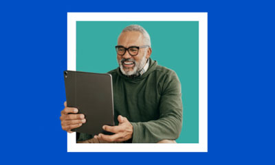 Man smiling at laptop screen