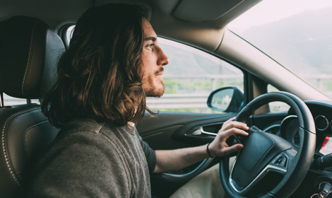 Man with long hair driving