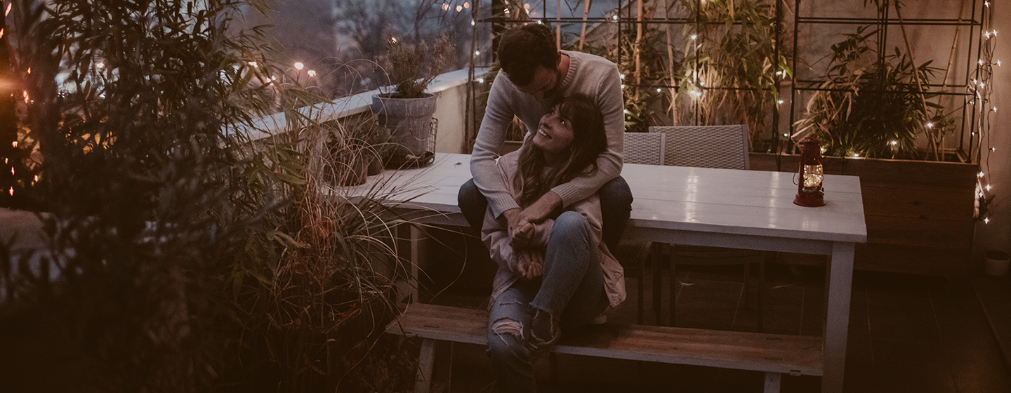 couple in embrace on outdoor patio