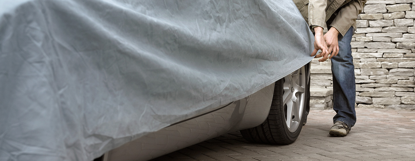 Person pulling car cover