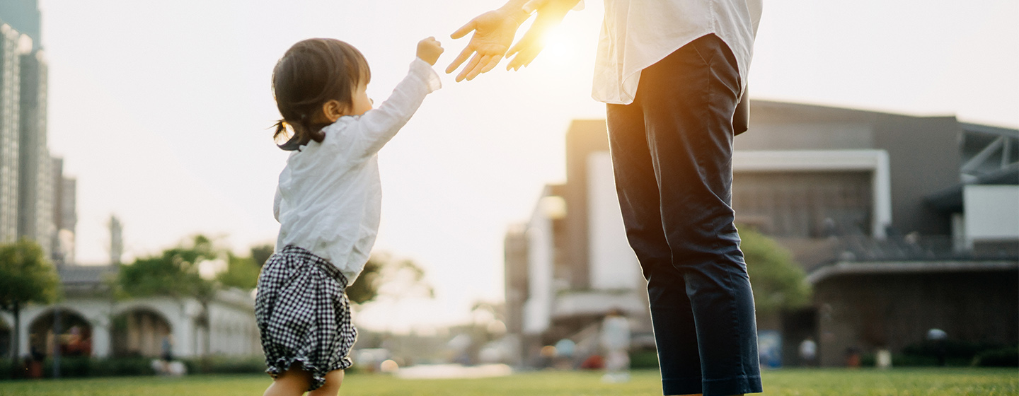 toddler reaching up for parent