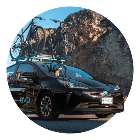 An Evo charsharing vehicle with bikes on the roof