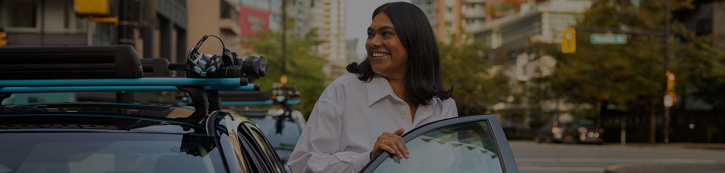 corporate woman stepping out of a shared Evo vehicle in the city