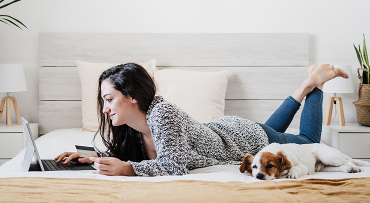 online shopping on laptop at home in bed