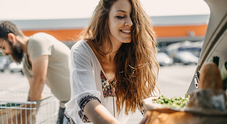 woman loading groceries into car