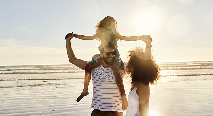 family on the beach during sunset