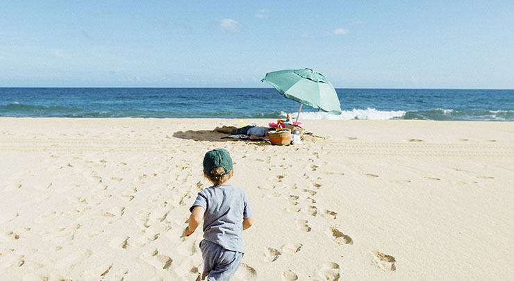 boy running on the beach