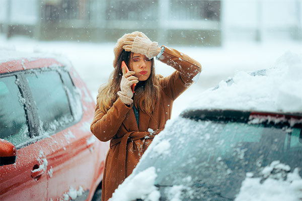 Woman stuck in a snow storm with car broken